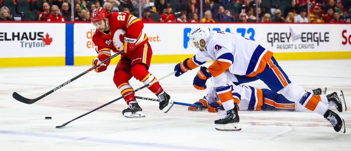 Calgary Flames right wing Matt Coronato (27) controls the puck against the New York Islanders during the second period at Scotiabank Saddledome