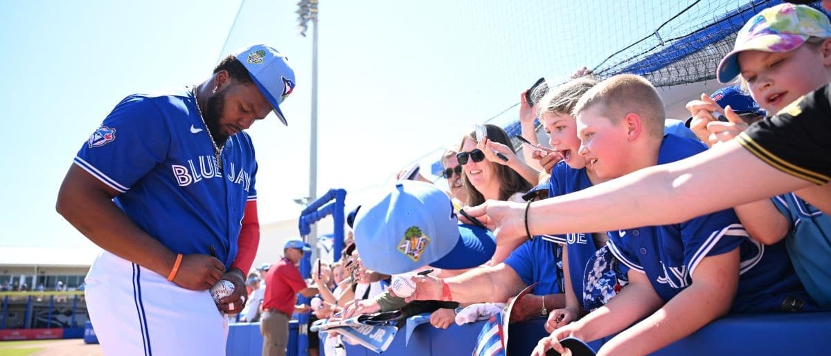 Toronto Blue Jays first baseman Vladimir Guerrero Jr. (27) signs autographs before the start of the game against the Philadelphia Phillies during spring training at TD Ballpark.