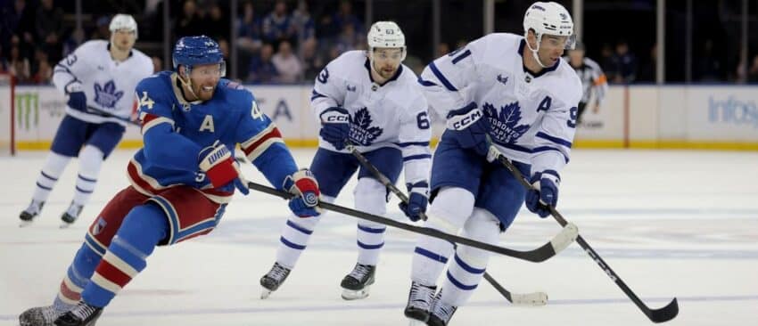 Toronto Maple Leafs center John Tavares (91) controls the puck against New York Rangers defenseman Vladislav Gavrikov (44) during the third period at Madison Square Garden