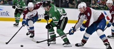 Dallas Stars center Justin Hryckowian (49) skates between Colorado Avalanche defenseman Devon Toews (7) and defenseman Cale Makar (8) during the game between the Stars and the Avalanche at American Airlines Center.