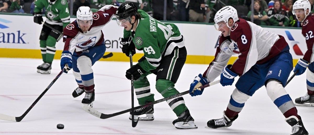 Dallas Stars center Justin Hryckowian (49) skates between Colorado Avalanche defenseman Devon Toews (7) and defenseman Cale Makar (8) during the game between the Stars and the Avalanche at American Airlines Center.