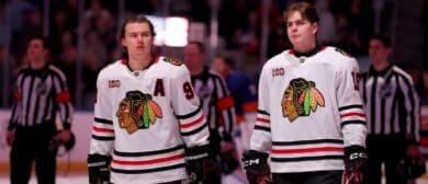 Chicago Blackhawks centers Connor Bedard (98) and Anton Frondell (15) stand for the US national anthem before a game against the New York Islanders at UBS Arena.