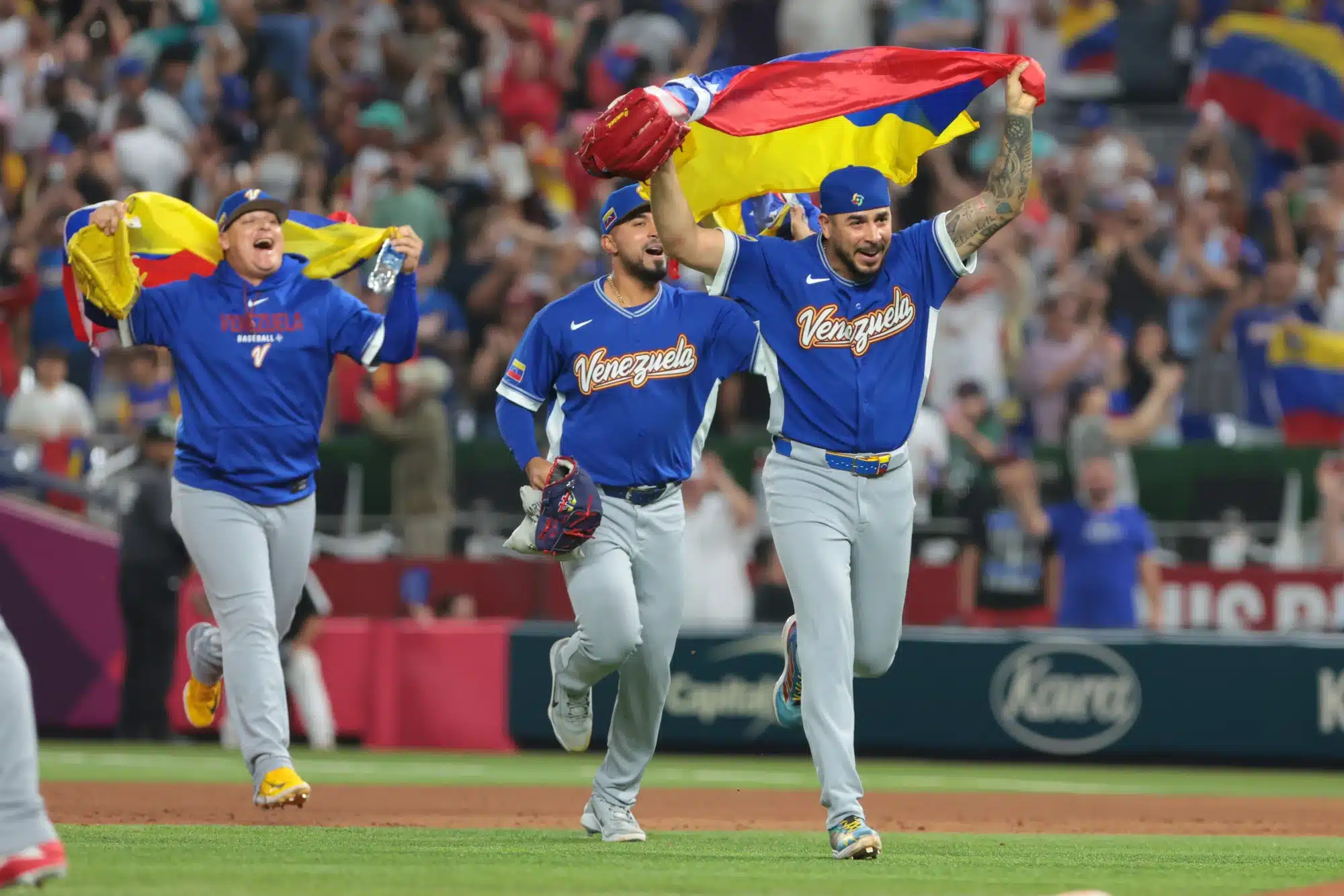 Mar 16, 2026; Miami, FL, United States; Venezuela pitcher José Buttó (70) and teammates celebrate after defeating Italy in a semifinal game of the 2026 World Baseball Classic at loanDepot Park. 