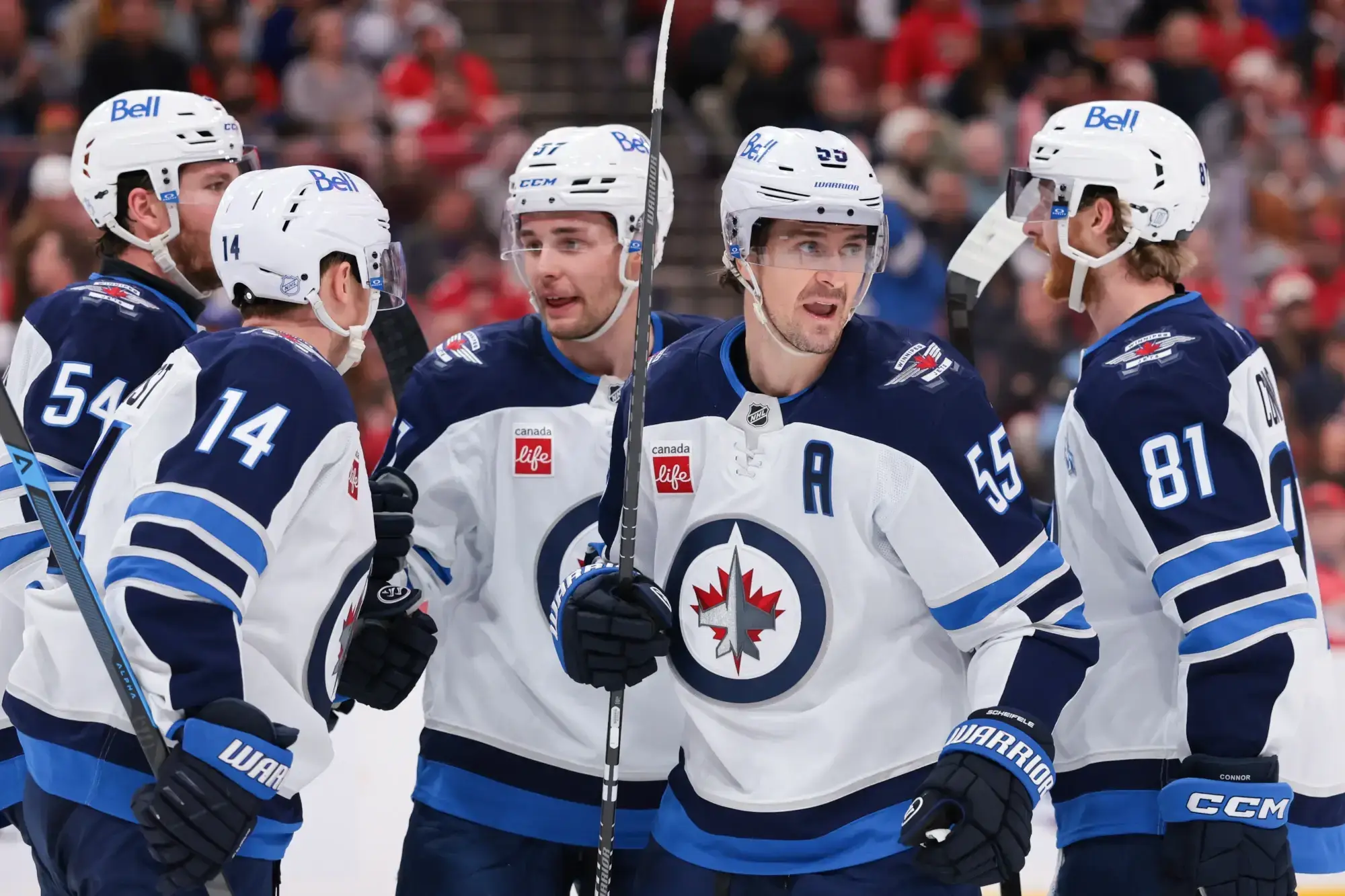 Jan 31, 2026; Sunrise, Florida, USA; Winnipeg Jets center Mark Scheifele (55) celebrates with teammates after scoring against the Florida Panthers during the third period at Amerant Bank Arena. 