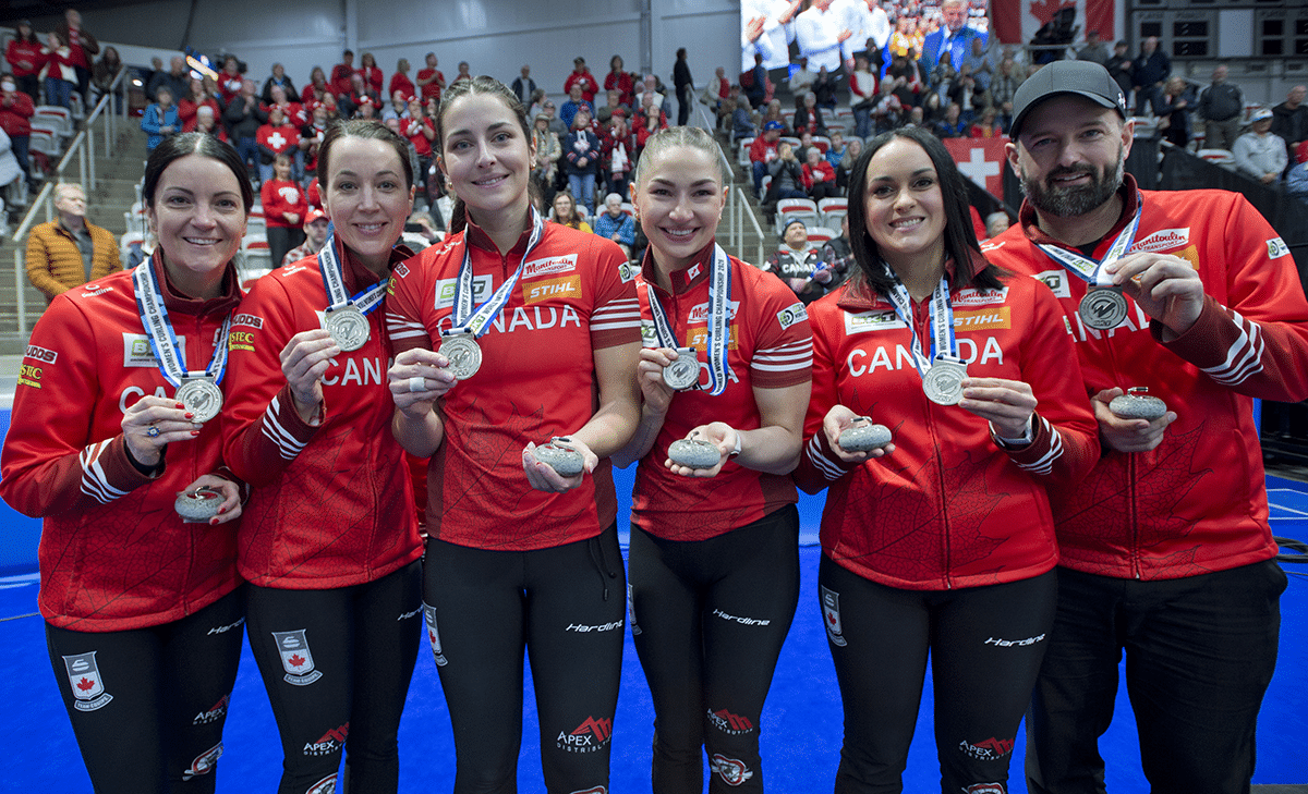 Team Canada posing with their silver medals and commemorative stones from the 2026 BKT World Women's Curling Championship.