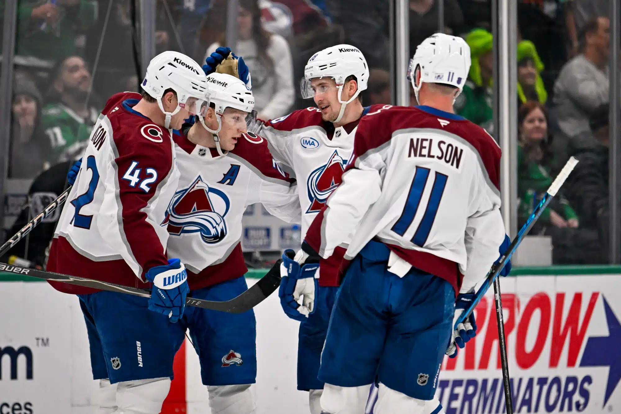 Apr 4, 2026; Dallas, Texas, USA; Colorado Avalanche defenseman Josh Manson (42) and center Nathan MacKinnon (29) and center Martin Necas (88) and center Brock Nelson (11) celebrates an empty goal scored by MacKinnon against the Dallas Stars during the third period at the American Airlines Center. 