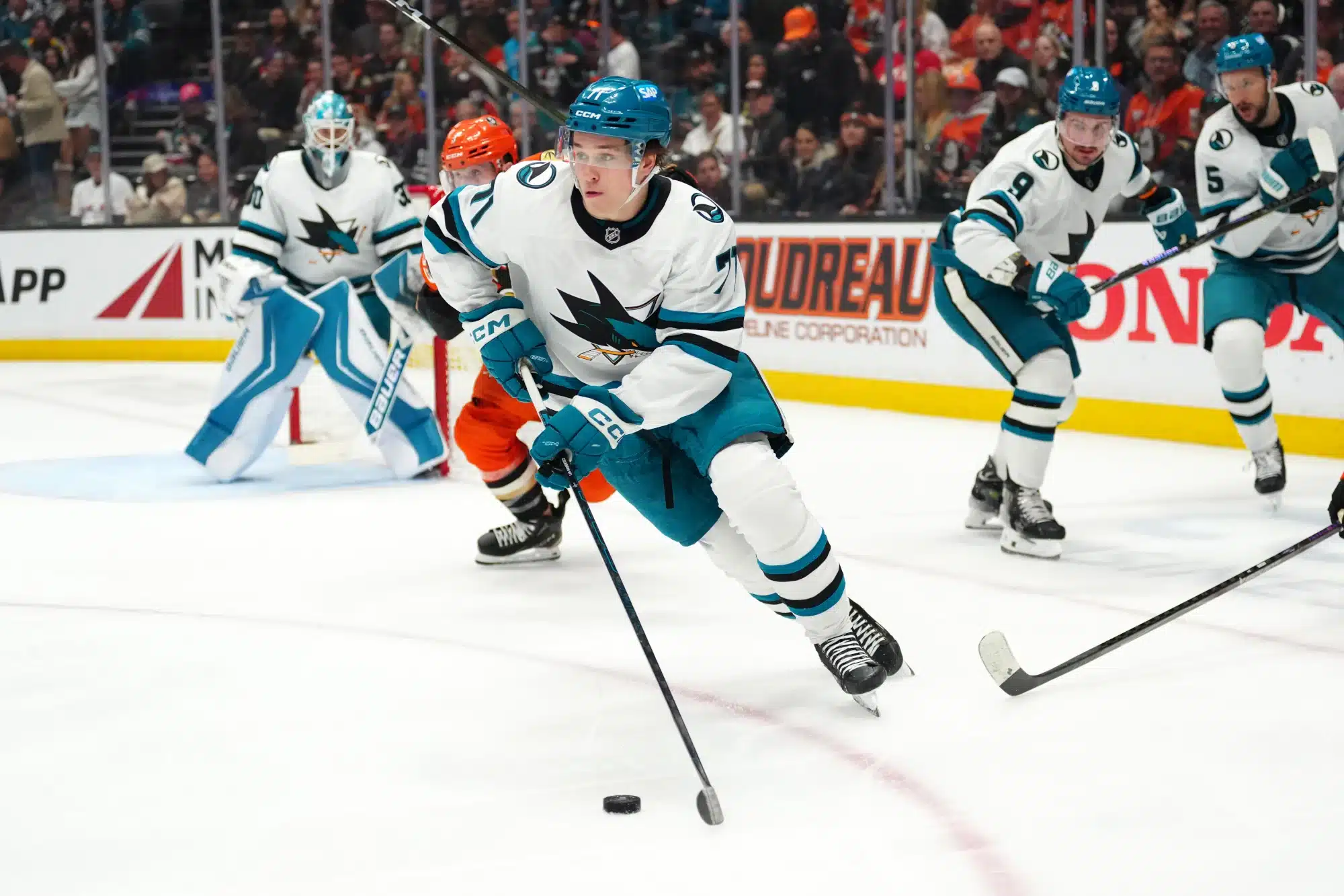Apr 9, 2026; Anaheim, California, USA; San Jose Sharks center Macklin Celebrini (71) skates with the puck against the Anaheim Ducks in the second period at the Honda Center.