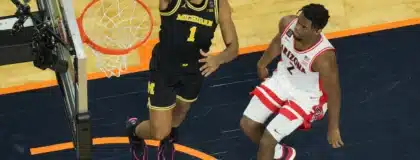 Apr 4, 2026; Indianapolis, IN, USA; Michigan Wolverines guard Trey McKenney (1) shoots against Arizona Wildcats guard Dwayne Aristode (2) in the first half during a semifinal of the Final Four of the men's 2026 NCAA Tournament at Lucas Oil Stadium.
