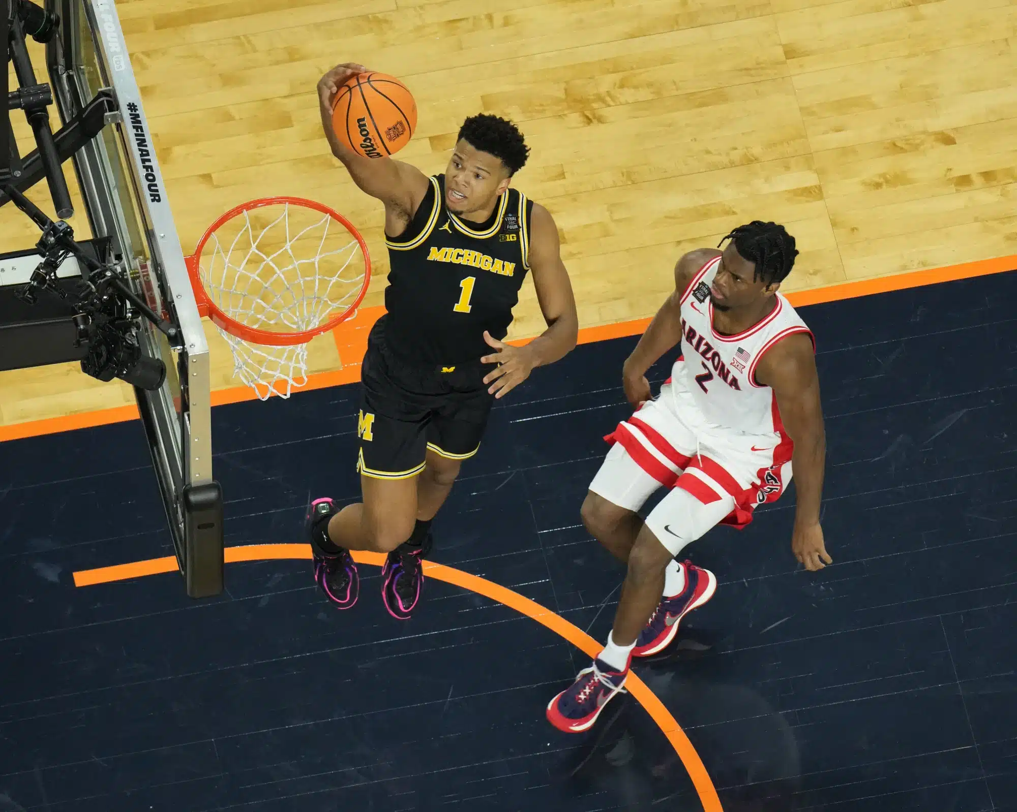Apr 4, 2026; Indianapolis, IN, USA; Michigan Wolverines guard Trey McKenney (1) shoots against Arizona Wildcats guard Dwayne Aristode (2) in the first half during a semifinal of the Final Four of the men's 2026 NCAA Tournament at Lucas Oil Stadium.