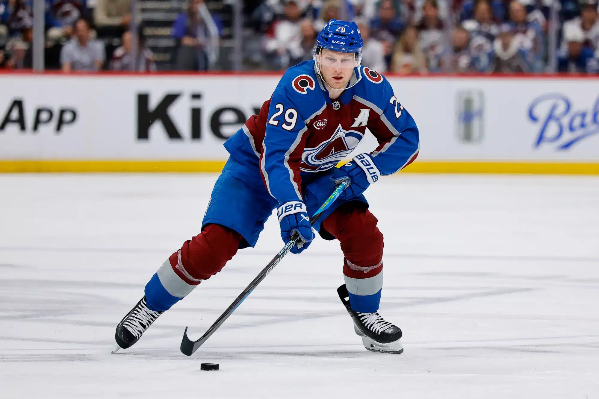 Apr 21, 2026; Denver, Colorado, USA; Colorado Avalanche center Nathan MacKinnon (29) controls the puck in the second period against the Los Angeles Kings in game two of the first round of the 2026 Stanley Cup Playoffs at Ball Arena.