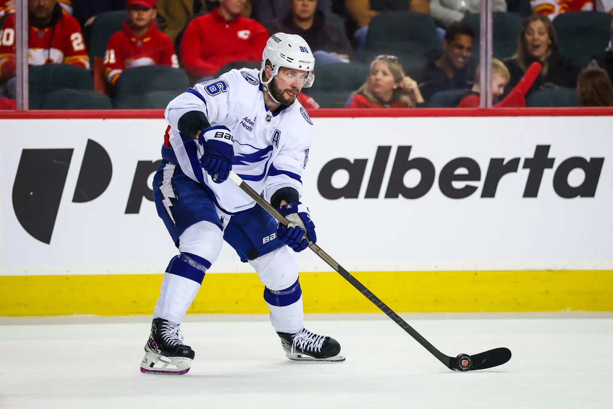 Mar 22, 2026; Calgary, Alberta, CAN; Tampa Bay Lightning right wing Nikita Kucherov (86) skates with the puck against the Calgary Flames during the third period at Scotiabank Saddledome.