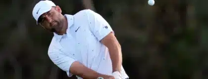 Apr 12, 2026; Augusta, Georgia, USA; Scottie Scheffler takes a shot on the 18th hole during the final round of the Masters Tournament at Augusta National Golf Club.