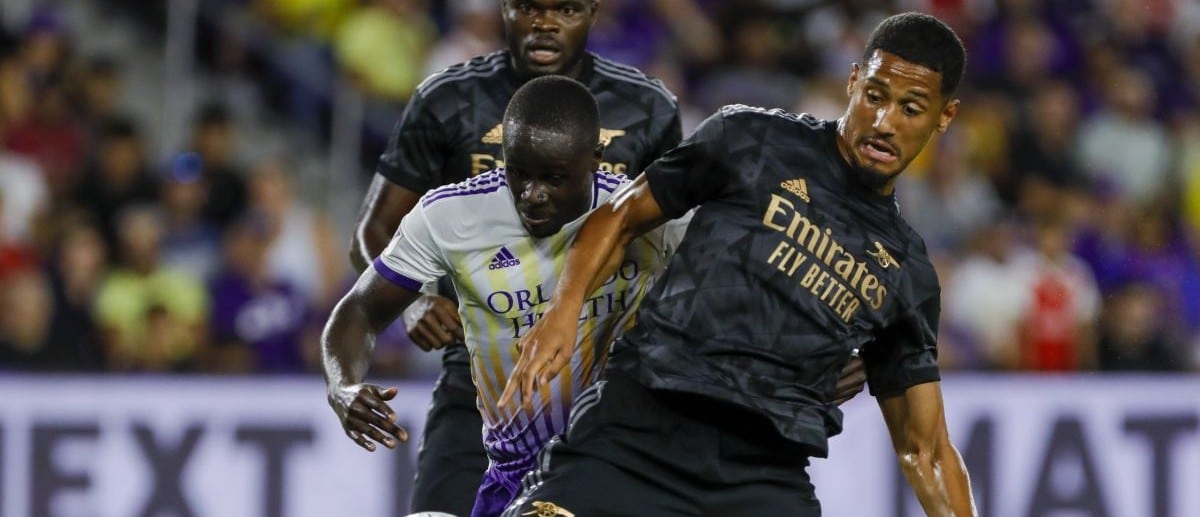 Arsenal defender William Saliba (12) protects the ball from Orlando City forward Benji Michel (19) during the second half at Exploria Stadium.