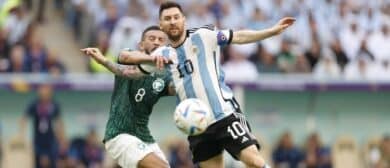 Argentina forward Lionel Messi (10) battles for the ball against Saudi Arabia midfielder Abdulellah Al-Malki (8) during a group stage match during the 2022 World Cup at Lusail Stadium.