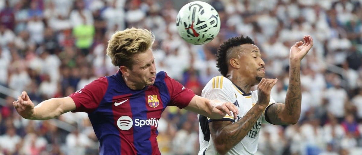 FC Barcelona midfielder Frenkie de Jong (21) and Real Madrid defender Eder Militao (3) battle for the ball during the first half at AT&T Stadium.