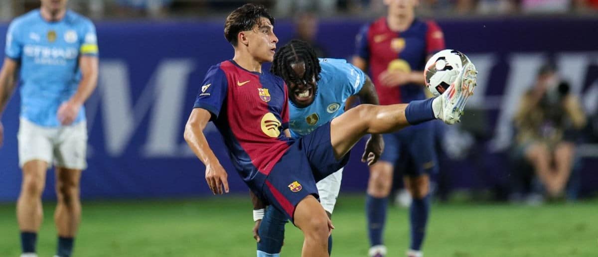 Barcelona forward Lamine Yamal (27) controls the ball against Manchester City in the second half during a Champions Tour friendly match at Camping World Stadium