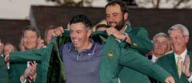 Scottie Scheffler places the green jacket on Rory McIlroy during the green jacket ceremony during the final round of the Masters Tournament at Augusta National Golf Club