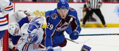 Colorado Avalanche center Nathan MacKinnon (29) collides into Edmonton Oilers goaltender Connor Ingram (39) in the second period at Ball Arena.
