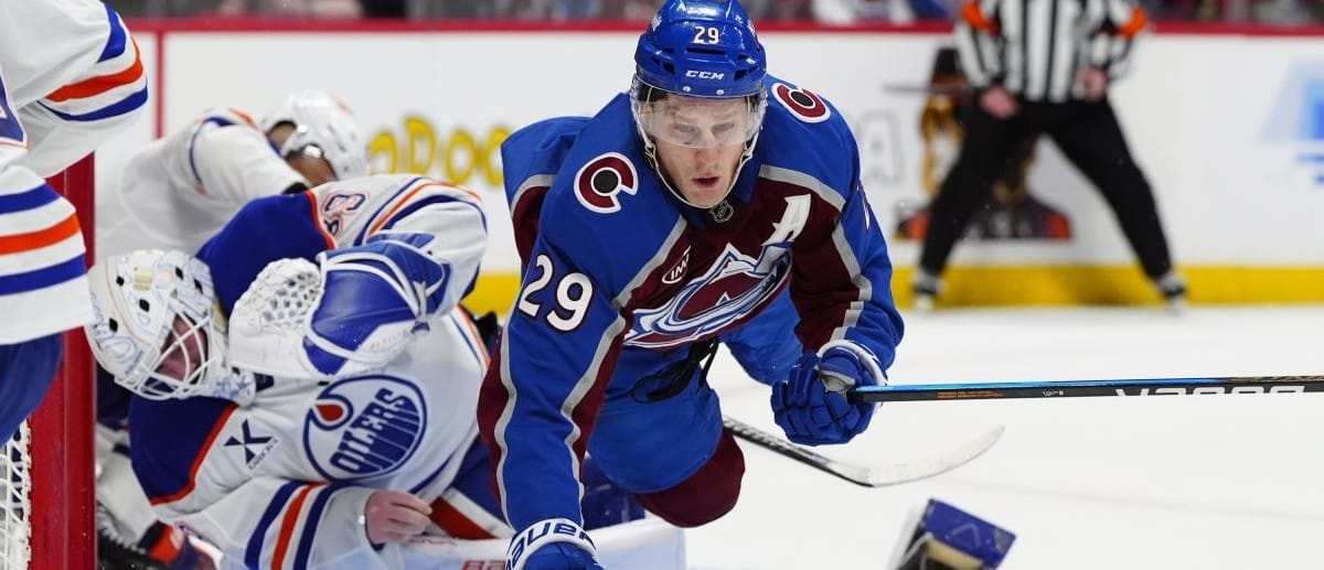 Colorado Avalanche center Nathan MacKinnon (29) collides into Edmonton Oilers goaltender Connor Ingram (39) in the second period at Ball Arena.