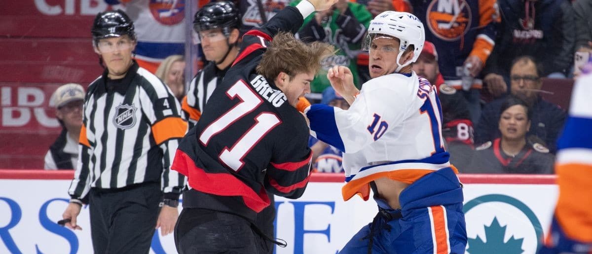 Ottawa Senators center Ridly Greig (71) fights with New York Islanders center Brayden Schenn (10) in the first period at the Canadian Tire Centre