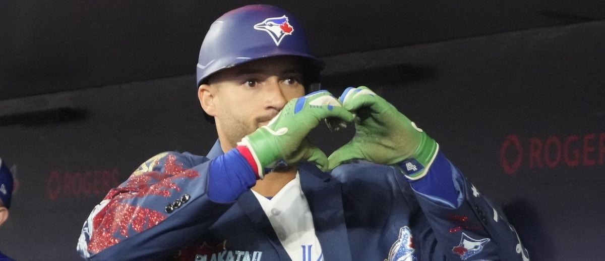 Toronto Blue Jays designated hitter George Springer (4) shows the heart symbol after his solo home run against the Athletics in the first inning at Rogers Centre