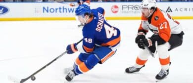 New York Islanders defenseman Matthew Schaefer (48) controls the puck with Philadelphia Flyers forward Noah Cates (27) in pursuit in the third period at UBS Arena.