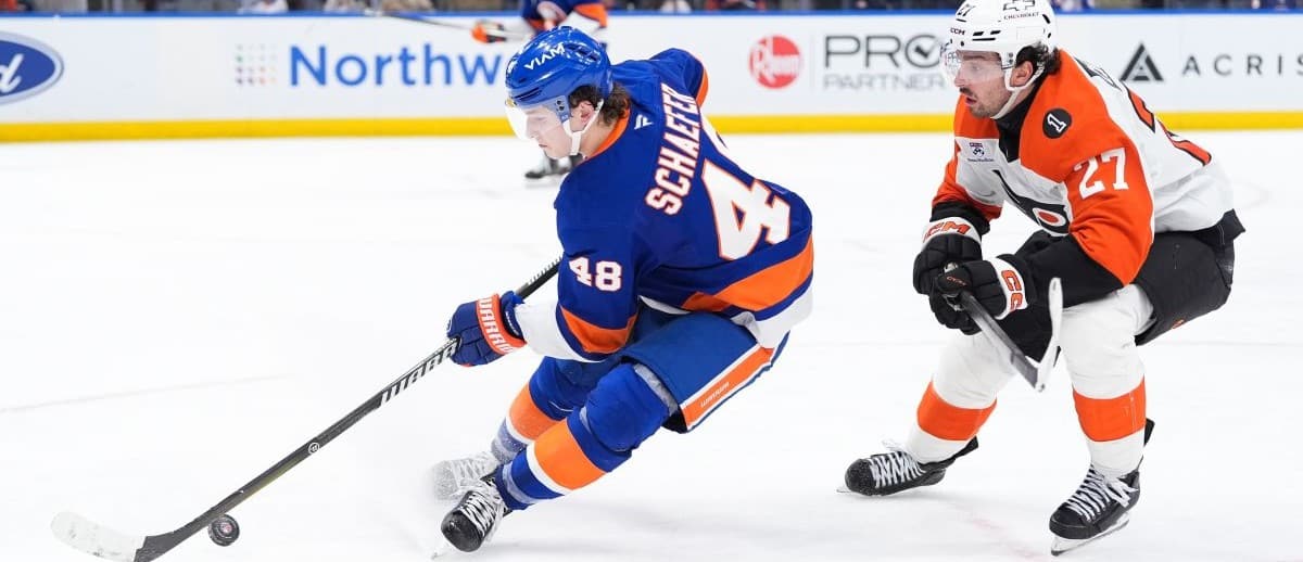 New York Islanders defenseman Matthew Schaefer (48) controls the puck with Philadelphia Flyers forward Noah Cates (27) in pursuit in the third period at UBS Arena.