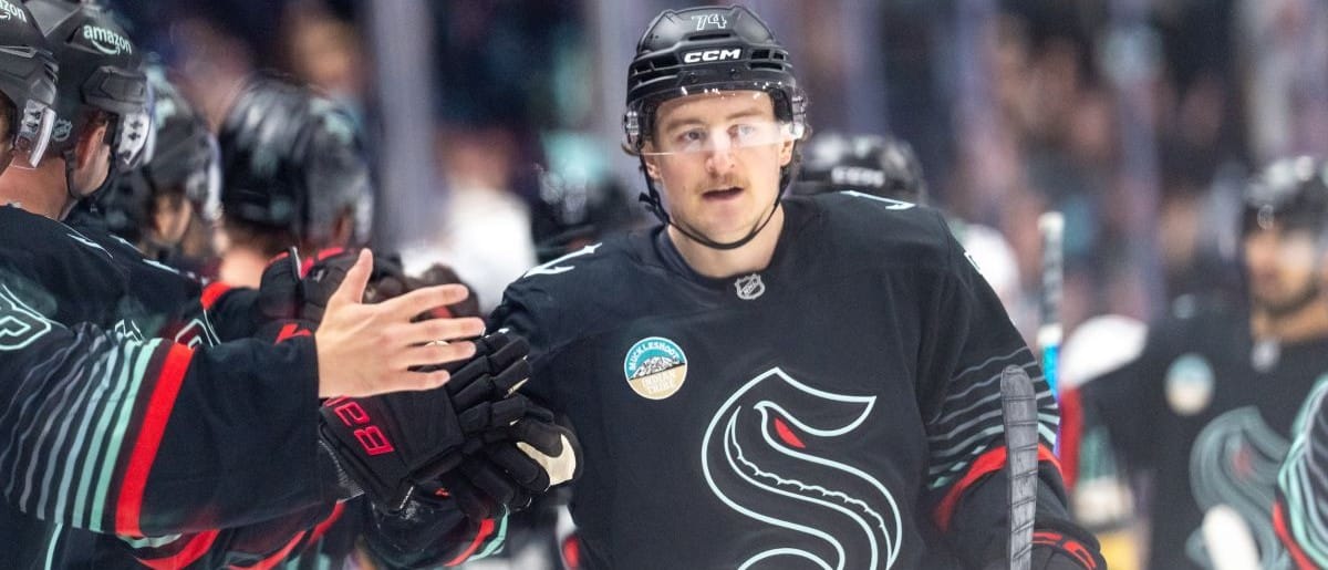 Seattle Kraken forward Bobby McMann (74) is congratulated by teammates on the bench after scoring a goal during the third period against the Vegas Golden Knights at Climate Pledge Arena.