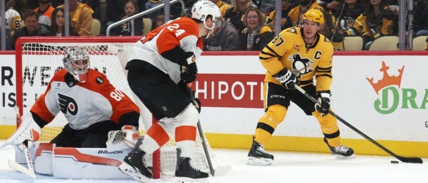 Pittsburgh Penguins center Sidney Crosby (87) handles the puck as Philadelphia Flyers goaltender Dan Vladar (80) and defenseman Nick Seeler (24) defend during the third period in game two of the first round of the 2026 Stanley Cup Playoffs at PPG Paints Arena.