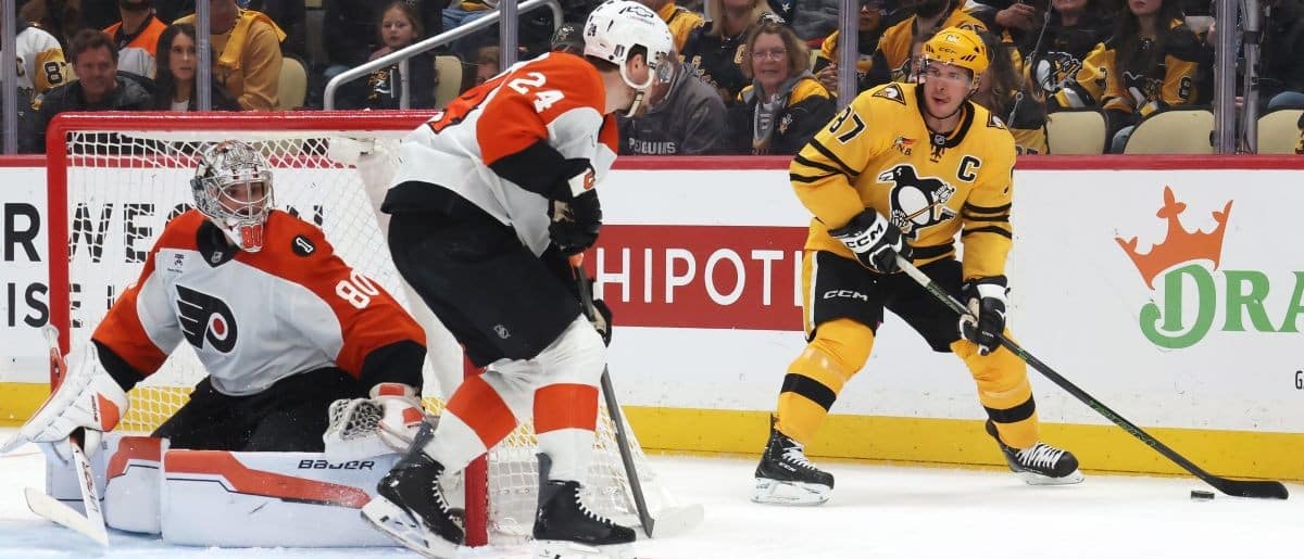 Pittsburgh Penguins center Sidney Crosby (87) handles the puck as Philadelphia Flyers goaltender Dan Vladar (80) and defenseman Nick Seeler (24) defend during the third period in game two of the first round of the 2026 Stanley Cup Playoffs at PPG Paints Arena.