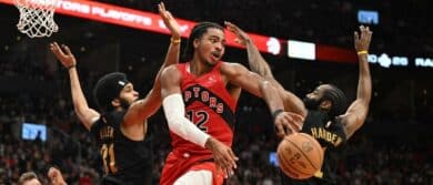 Toronto Raptors forward Collin Murray-Boyles (12) passes the ball away from Cleveland Cavaliers center Jarrett Allen (31) and guard James Harden (1) during game four of the first round of the 2026 NBA Playoffs at Scotiabank Arena.