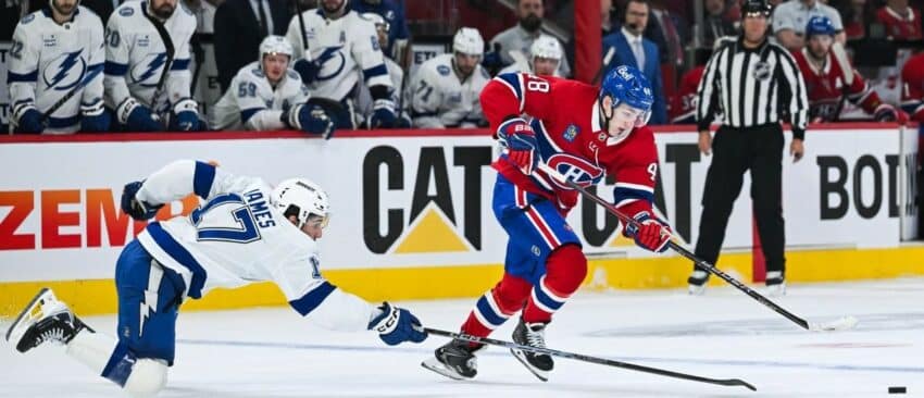 Montreal Canadiens defenseman Lane Hutson (48) plays the puck against Tampa Bay Lightning center Dominic James (17) during the third period in game four of the first round of the 2026 Stanley Cup Playoffs at Bell Centre