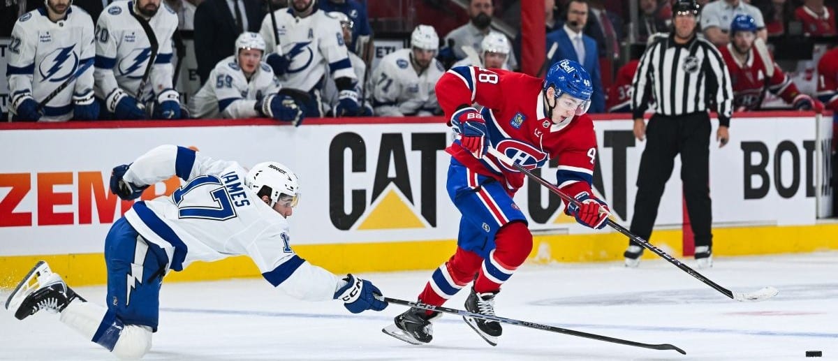 Montreal Canadiens defenseman Lane Hutson (48) plays the puck against Tampa Bay Lightning center Dominic James (17) during the third period in game four of the first round of the 2026 Stanley Cup Playoffs at Bell Centre