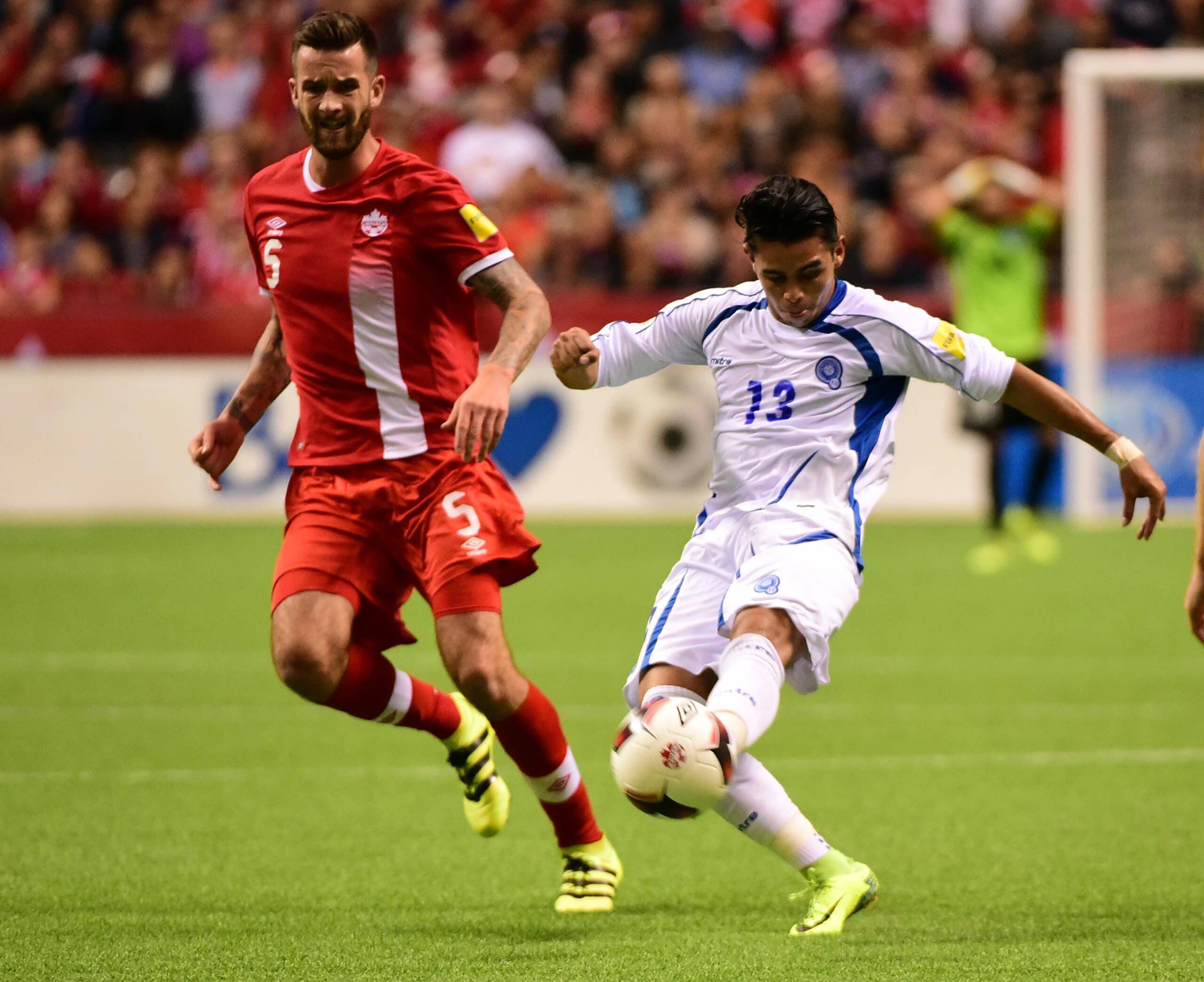 Sep 6, 2016; Vancouver, Canada; El Salvador player Larin Hernandez (13) battles for the ball against Canada player David Edgar (5) during the second half at B.C. Place Stadium. Team Canada won 3-1. Mandatory Credit: Anne-Marie Sorvin-USA TODAY Sports