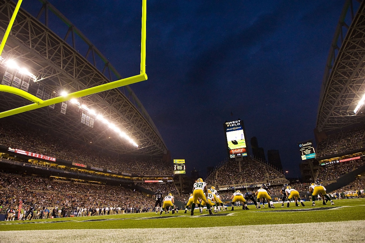 Packed NFL stadium during a night game showing intense crowd atmosphere and home-field advantage