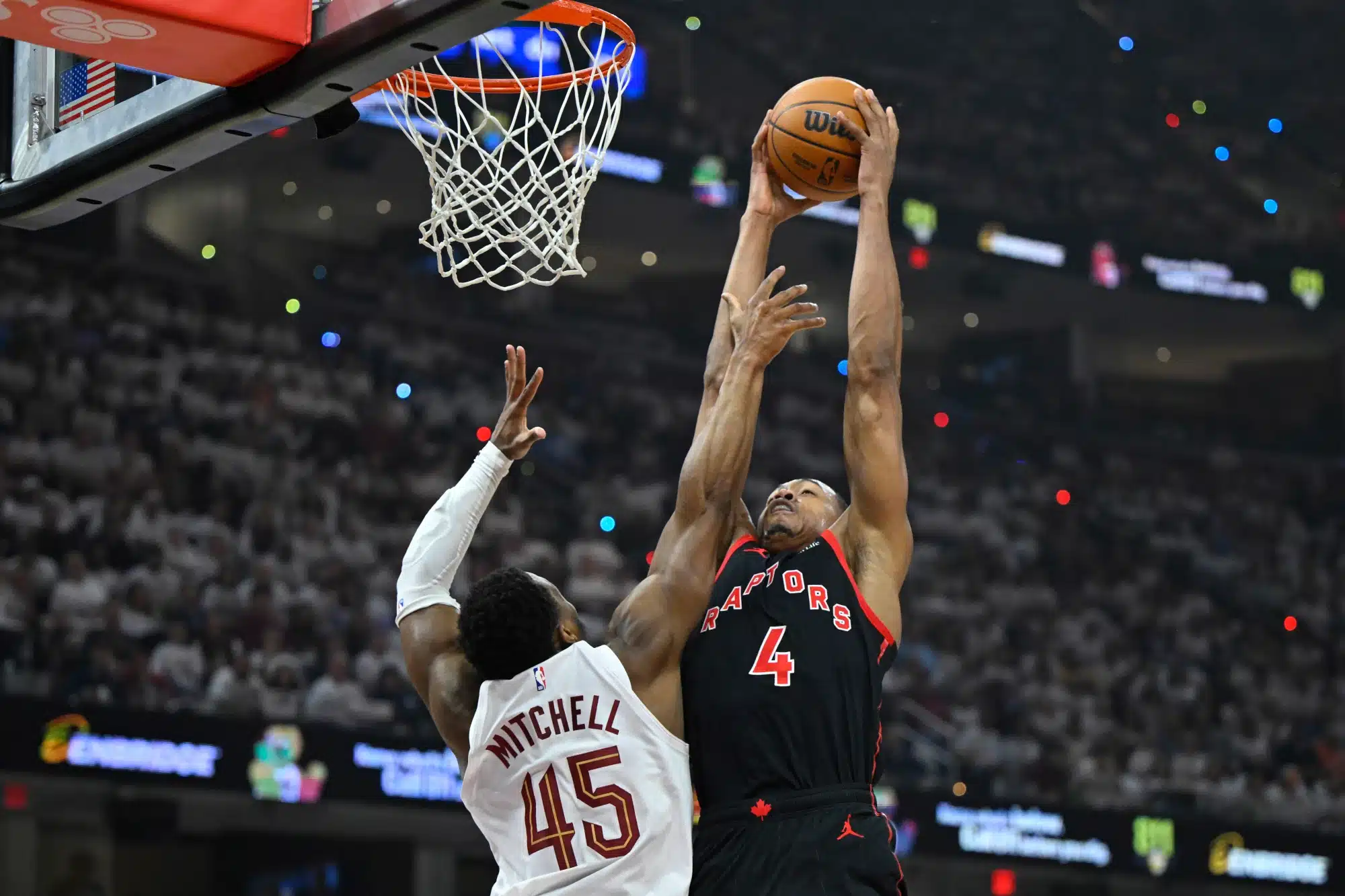 Apr 29, 2026; Cleveland, Ohio, USA; Toronto Raptors forward Scottie Barnes (4) drives to the basket beside Cleveland Cavaliers guard Donovan Mitchell (45) in the first quarter of game five of the first round of the 2026 NBA Playoffs at Rocket Arena. 