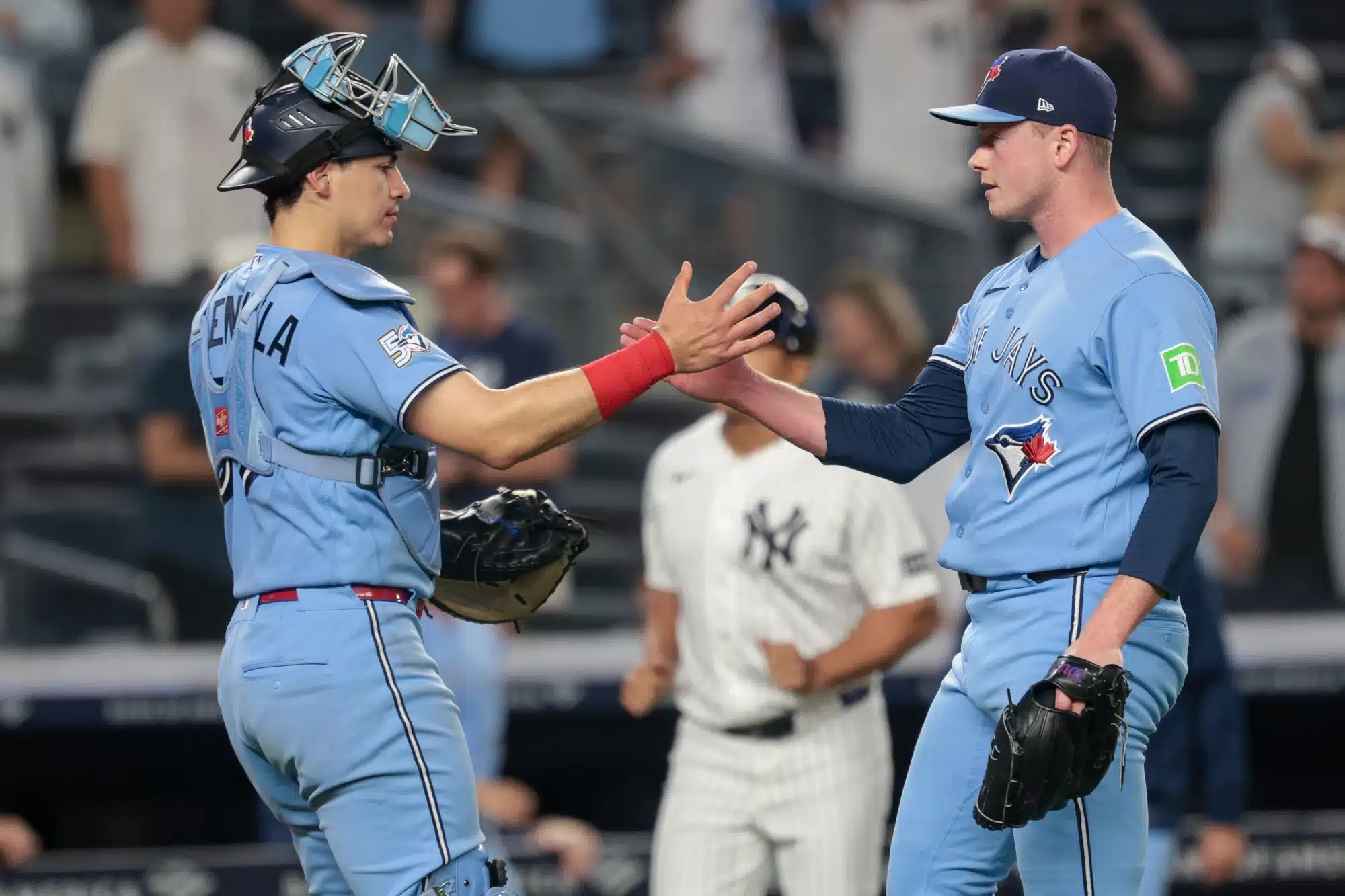 May 20, 2026; Bronx, New York, USA; Toronto Blue Jays catcher Brandon Valenzuela (59) celebrates with pitcher Louis Varland (77) after the game against the New York Yankees at Yankee Stadium. 