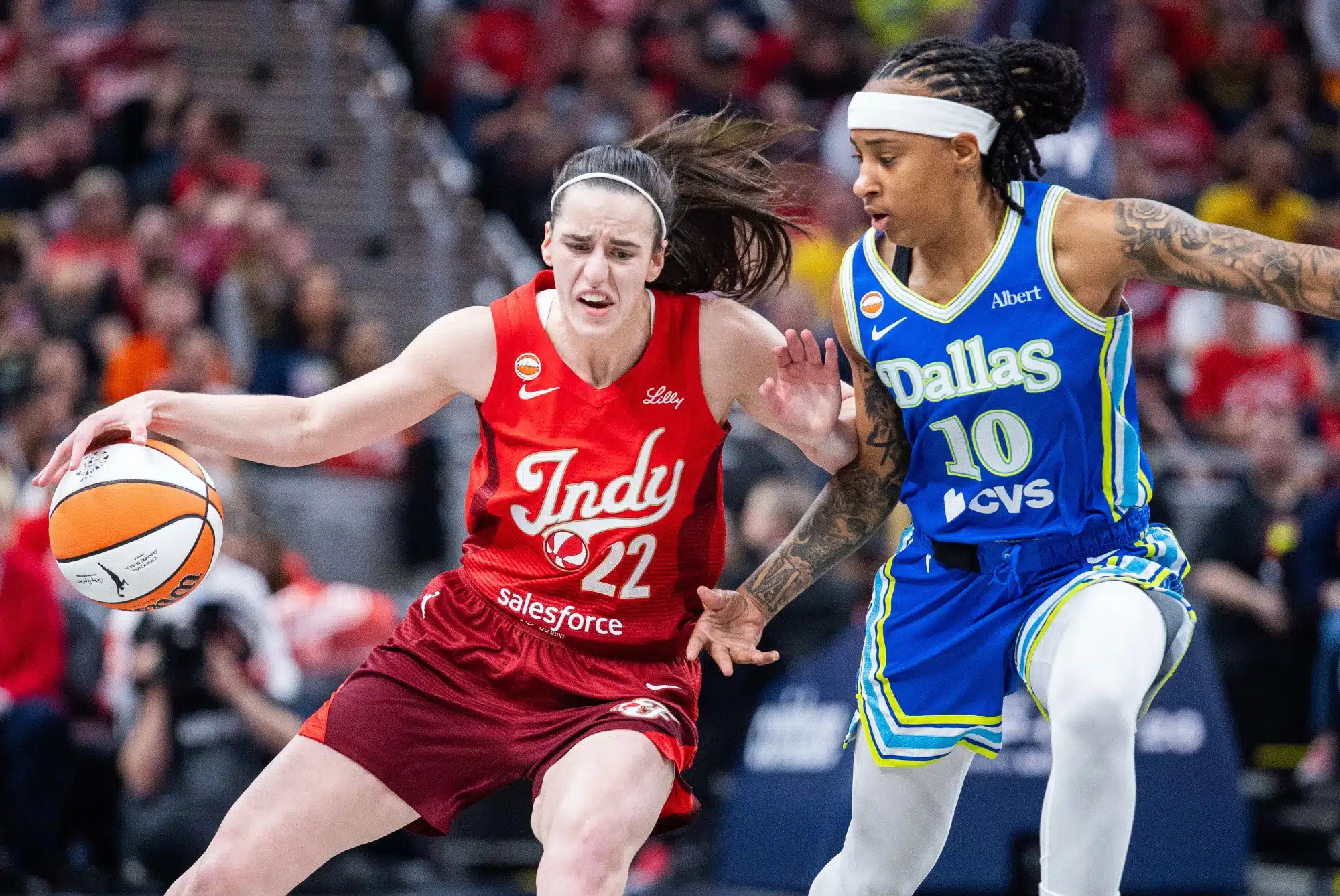 May 9, 2026; Indianapolis, Indiana, USA; Indiana Fever guard Caitlin Clark (22) dribbles the ball while Dallas Wings guard Aziaha James (10) defends in the first half at Gainbridge Fieldhouse.