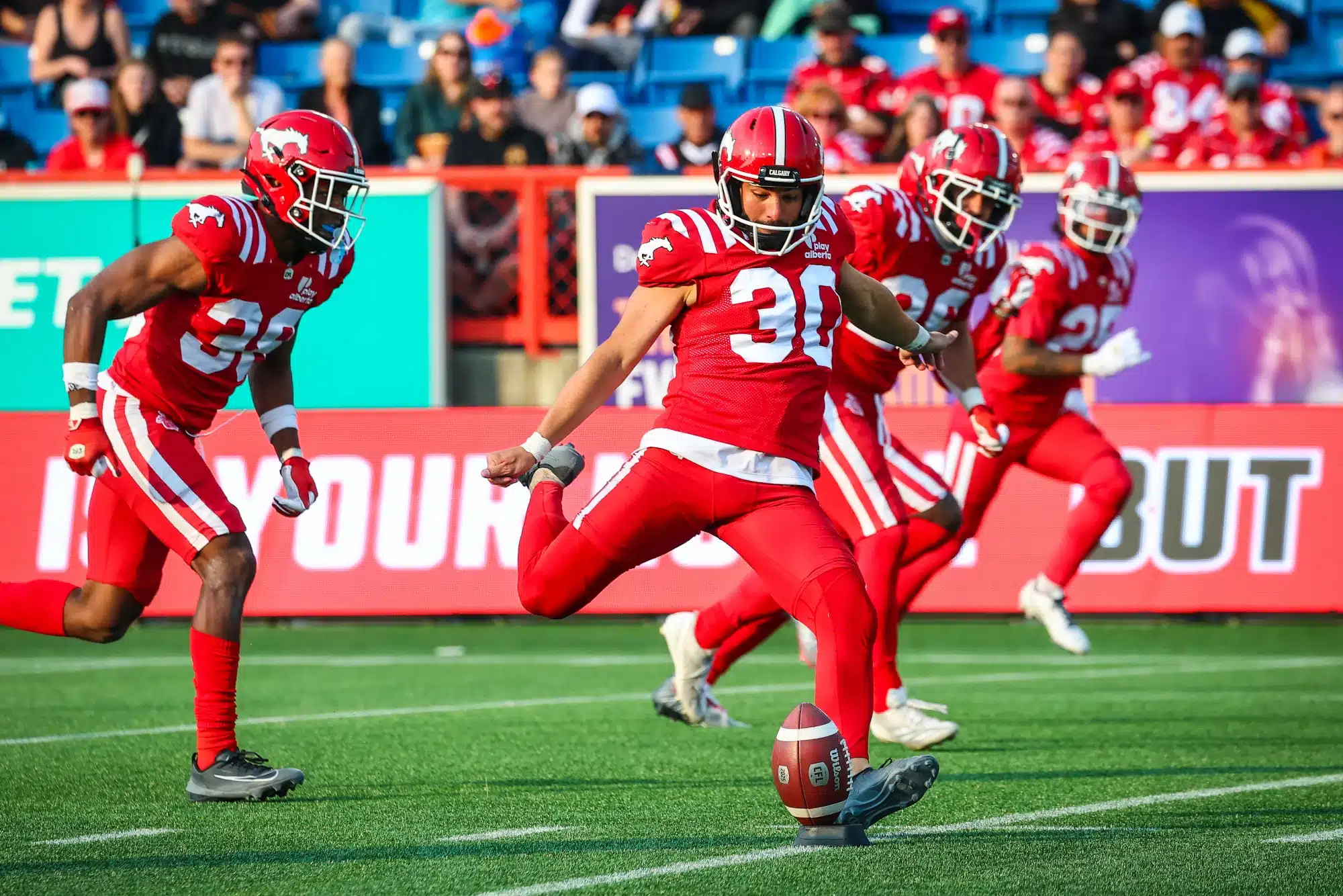 Jun 7, 2025; Calgary, Alberta, Canada; Calgary Stampeders kicker Rene Paredes (30) kicks the ball against the Hamilton Tiger-Cats during the second half at McMahon Stadium.