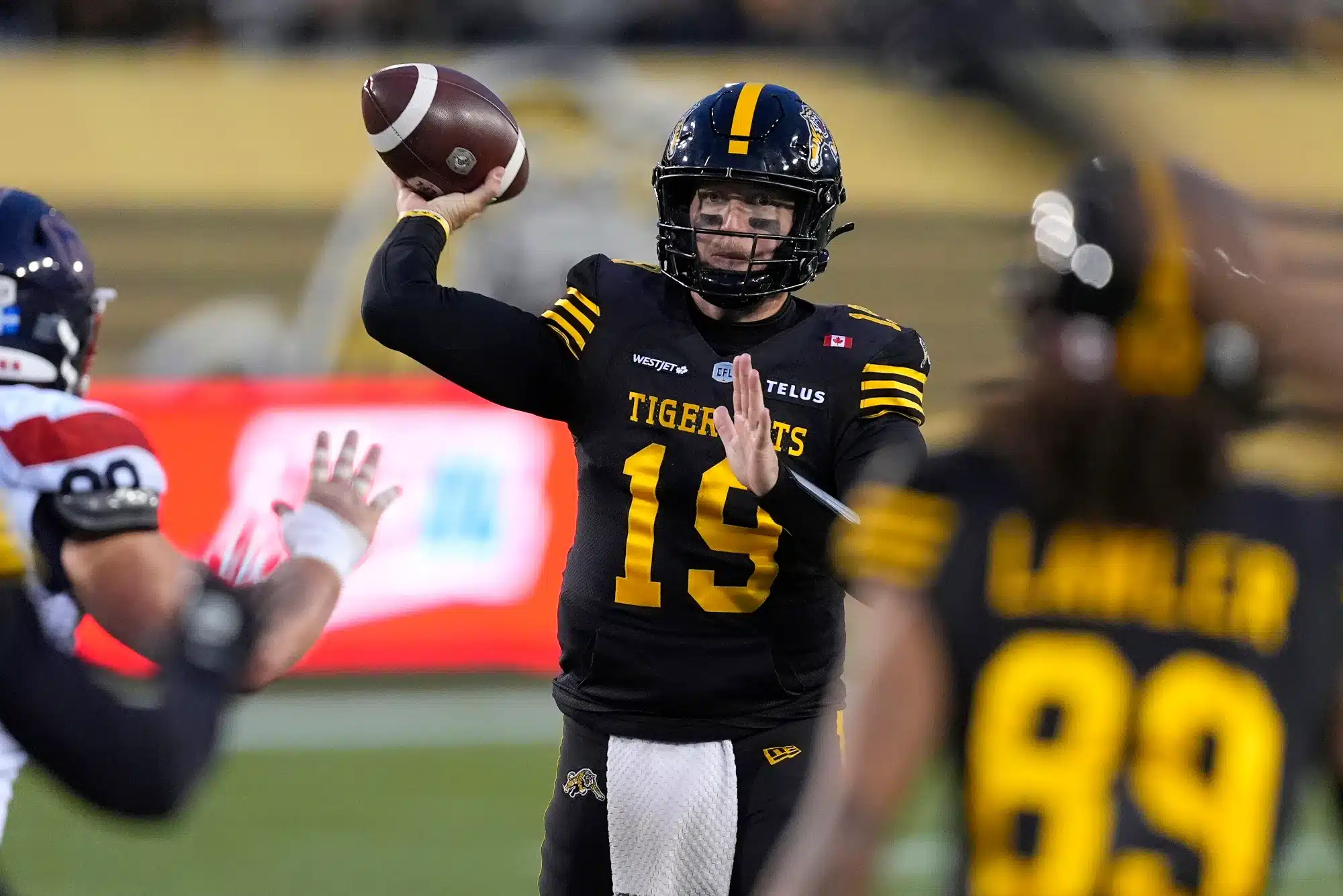Nov 8, 2025; Hamilton, Ontario, Canada; Hamilton Tiger-Cats quarterback Bo Levi Mitchell (19) goes to throw a pass against the Montreal Alouettes during the second half at Hamilton Stadium