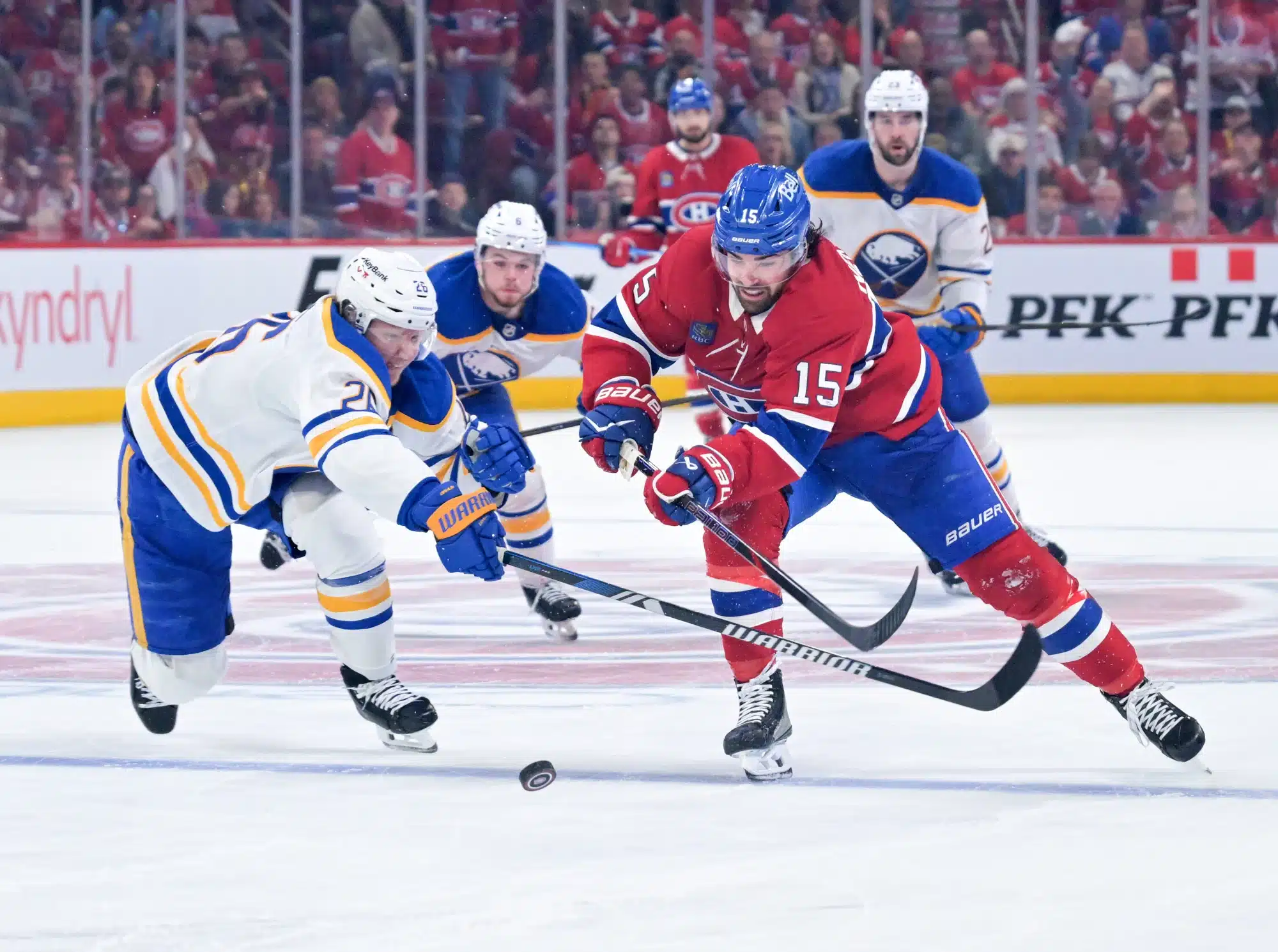 May 10, 2026; Montreal, Quebec, CAN; Montreal Canadiens forward Alex Newhook (15) on his way to score an empty net goal and Buffalo Sabres defenseman Rasmus Dahlin (26) defending during the third period in game three of the second round of the 2026 Stanley Cup Playoffs at the Bell Centre.