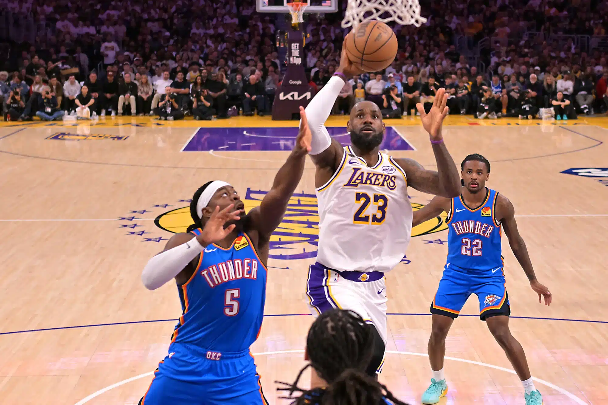 May 9, 2026; Los Angeles, California, USA; Los Angeles Lakers forward LeBron James (23) drives past Oklahoma City Thunder guard Luguentz Dort (5) during game three of the second round of the 2026 NBA Playoffs at Crypto.com Arena.