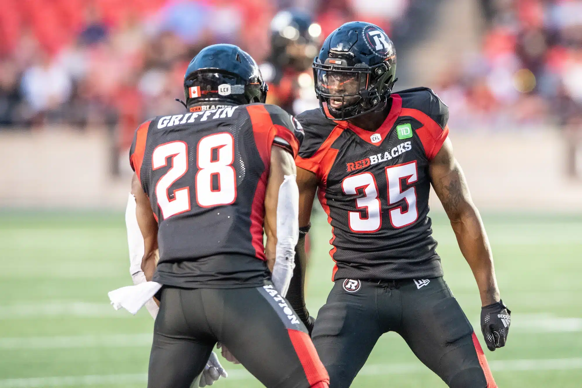Jun 15, 2023; Ottawa, Ontario, CAN; Ottawa REDBLACKS lineback Frankie Griffin (28) and defensive back Douglas Coleman (35) celebrate a broken play against the Calgary Stampeders in the first half against the at TD Place.