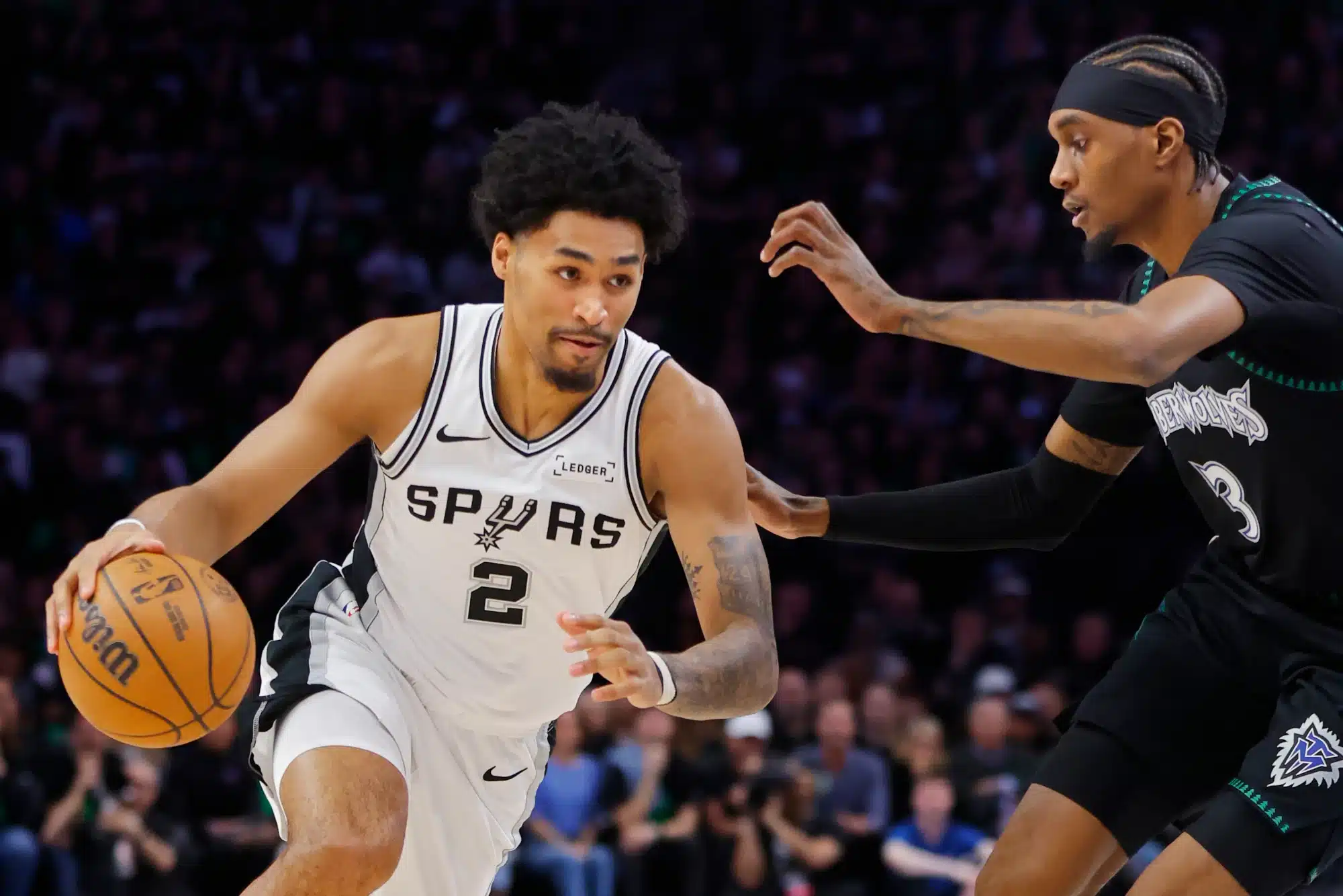 May 10, 2026; Minneapolis, Minnesota, USA; San Antonio Spurs guard Dylan Harper (2) works around Minnesota Timberwolves forward Jaden McDaniels (3) in the first quarter of game four of the second round of the 2026 NBA Playoffs at Target Center.