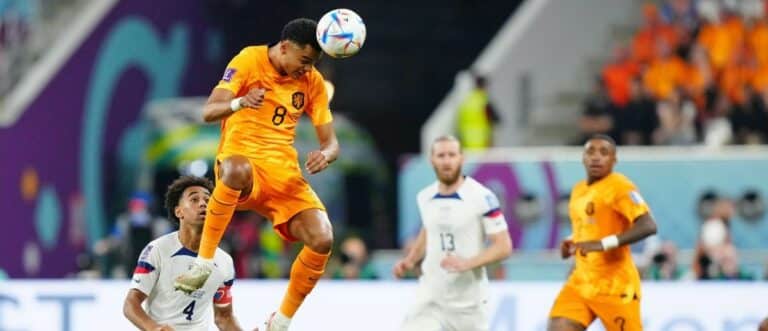 Netherlands forward Cody Gakpo (8) heads the ball against the United States of America during the second half of a round of sixteen match in the 2022 FIFA World Cup at Khalifa International Stadium