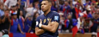 France forward Kylian Mbappe (10) celebrates after scoring a goal against Argentina on a penalty kick for his third goal of the match during extra time of the 2022 World Cup final at Lusail Stadium.