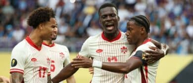 Canada forward Jonathan David (10) celebrates with forward Tani Oluwaseyi (12) and forward Tajon Buchanan (17) after scoring a goal against Guatemala in the first half during a quarterfinal match of the 2025 Gold Cup at U.S. Bank Stadium.