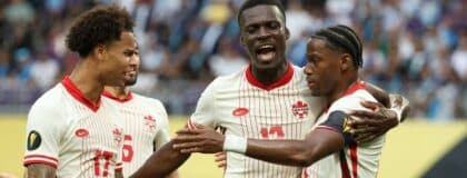 Canada forward Jonathan David (10) celebrates with forward Tani Oluwaseyi (12) and forward Tajon Buchanan (17) after scoring a goal against Guatemala in the first half during a quarterfinal match of the 2025 Gold Cup at U.S. Bank Stadium.