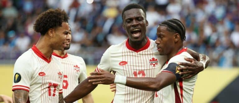 Canada forward Jonathan David (10) celebrates with forward Tani Oluwaseyi (12) and forward Tajon Buchanan (17) after scoring a goal against Guatemala in the first half during a quarterfinal match of the 2025 Gold Cup at U.S. Bank Stadium.