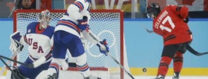 Macklin Celebrini (17) of Canada shoots against Connor Hellebuyck (37) of the United States in the men's ice hockey gold medal game during the Milano Cortina 2026 Olympic Winter Games at Milano Santagiulia Ice Hockey Arena